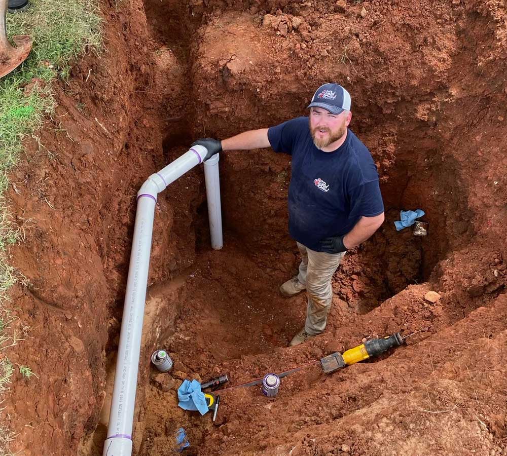 luke kelley owner of red beard plumbing working on sewer line