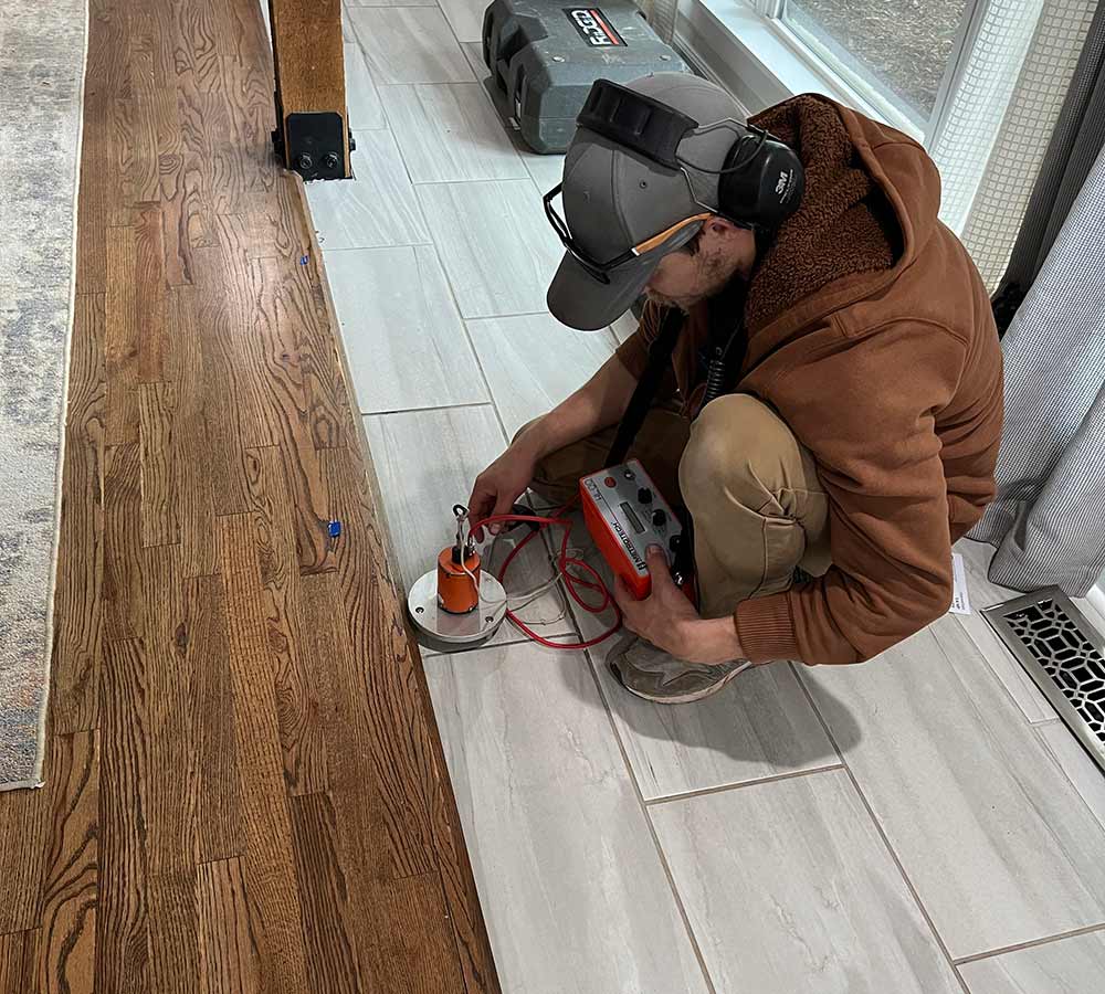 red beard plumber using a machine to detect leaks